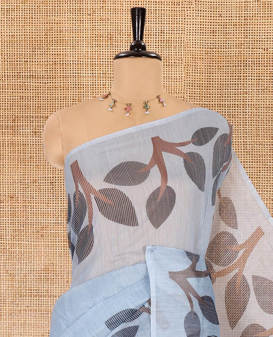 Grey plain linen cotton saree, branches and leaves printed border, printed pallu, and a contrast plain blouse
