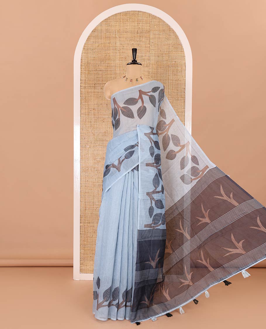 Grey plain linen cotton saree, branches and leaves printed border, printed pallu, and a contrast plain blouse
