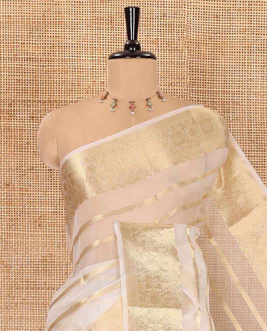 Half-white zari leaf vine design semi-organza saree, traditional zari design border, zari striped pallu, and a matching blouse