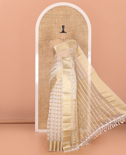 Half-white zari leaf vine design semi-organza saree, traditional zari design border, zari striped pallu, and a matching blouse