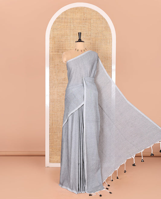 Borderless Sliver Grey Plain Khadi Mul Cotton Saree Features a Self-Pallu with Tassels, and a Matching Blouse
