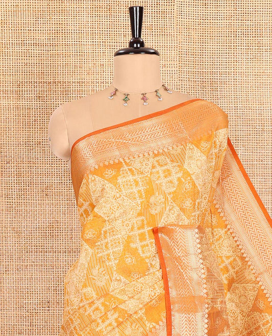 Mustard Semi-Tussar Saree Meticulously Crafted with Floral-Enclosed Diamond Patterns Printed Across the Body, Featuring a Subtly Woven Border with Traditional Zari Designs, and a Pallu Elevated with Zari Stripes, Paired with a Matching Blouse