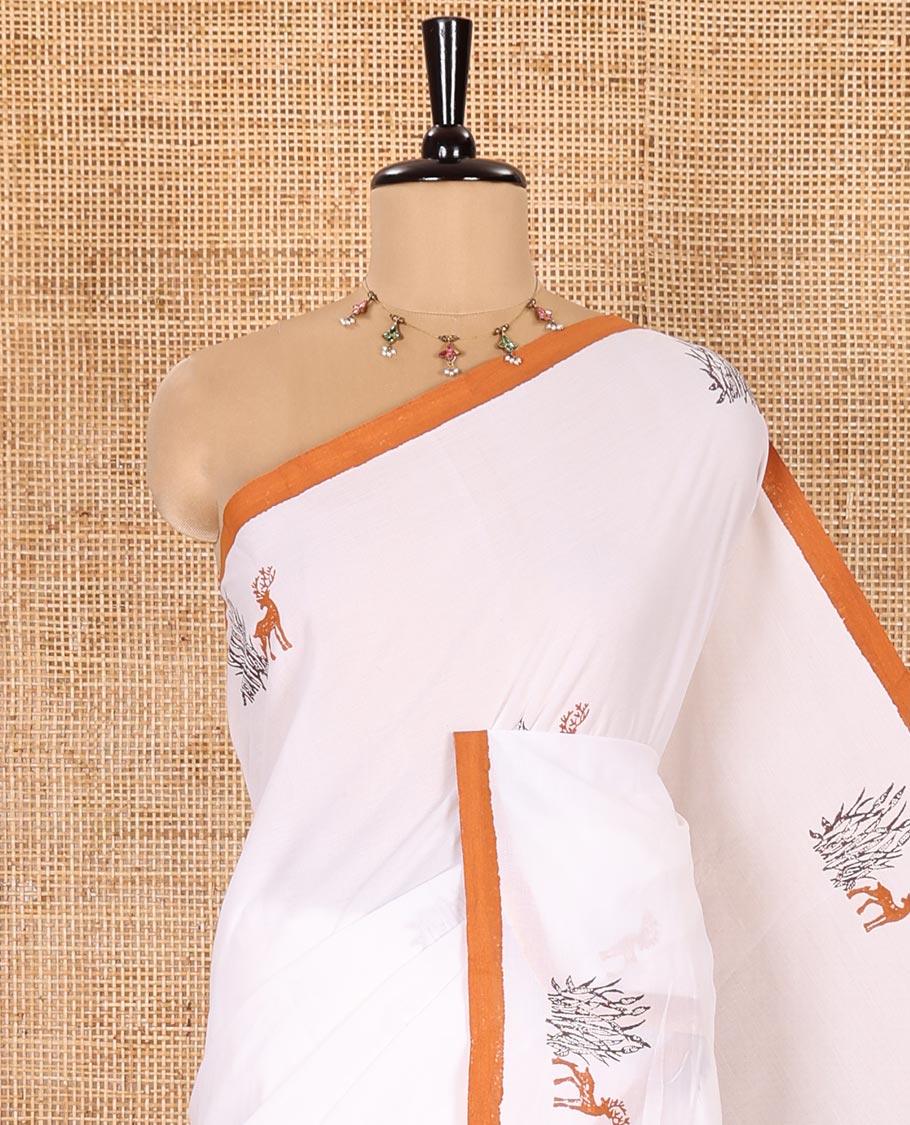 Cream South Cotton Saree Adorned with Deer Motifs Printed All Over Its Body, Complemented by a Contrast Plain Border, and Paired with a Contrast Floral Printed Blouse