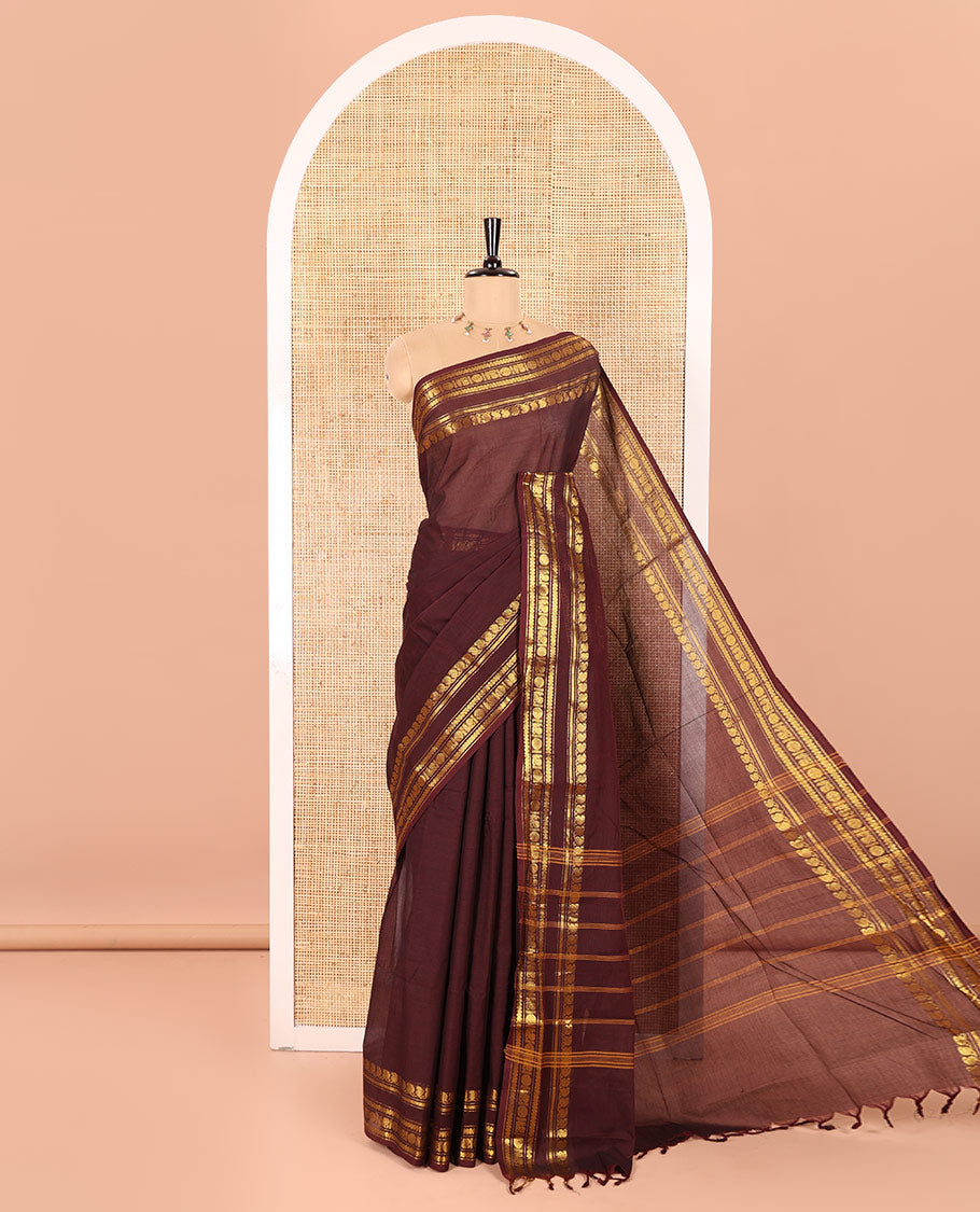 Coffee Brown Plain Chettinad Cotton Saree Graced with a Gleaming Zari Rettai Pettu Border Featuring Peacock, Rudraksham, and Neli Designs, Subtly Striped Pallu, and Paired with a Matching Blouse