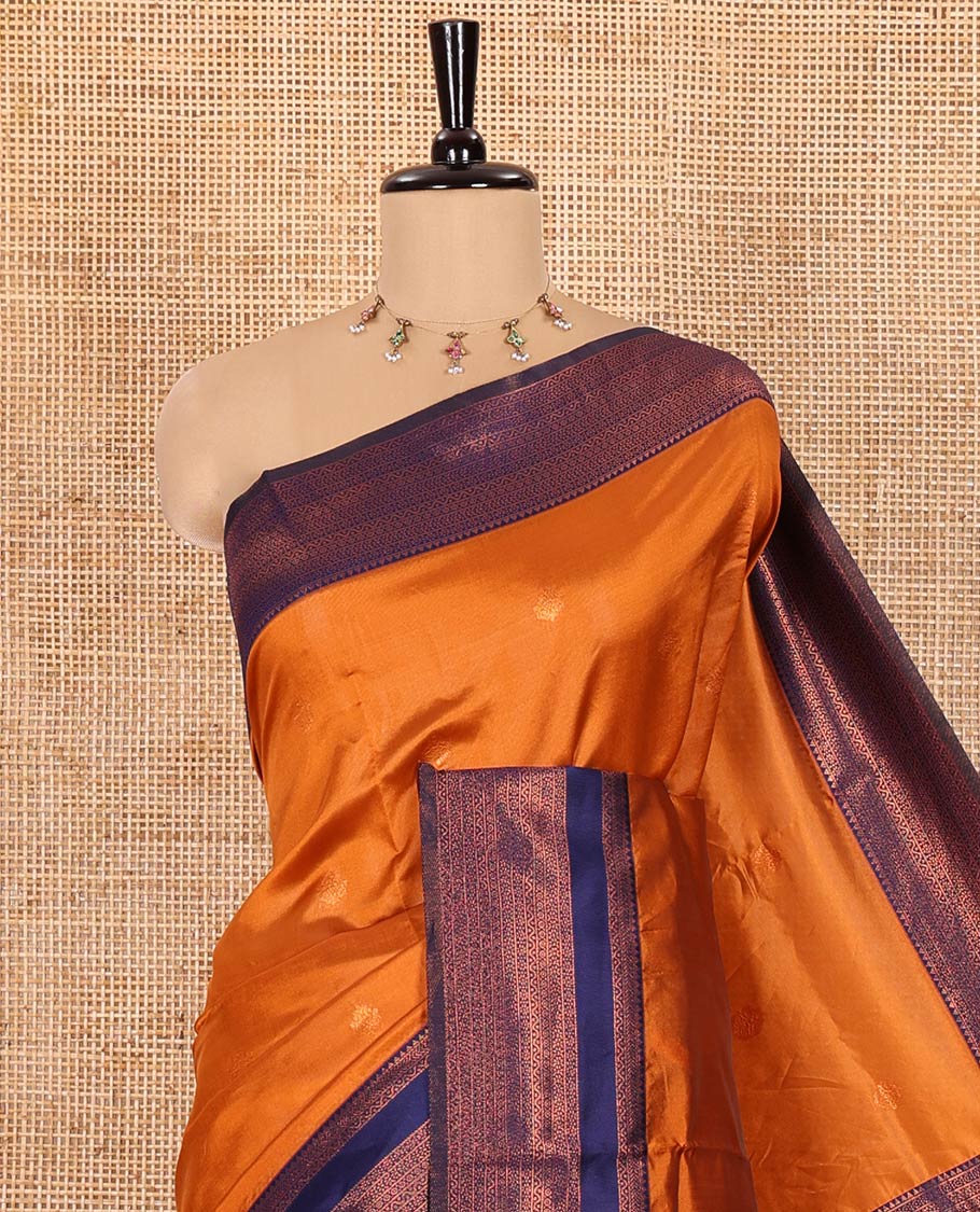 Orange Kanchi Silk Saree, Adorned with Zari Buttas All Over Its Body, Complemented by Contrast Rettai Pettu Traditional Zari Design Border, Gracefully Embellished Pallu, and Paired with a Contrast Blouse