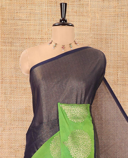 Navy Blue Tissue-Cotton Blended Saree, Subtly Sparkled with Vertical Stripes on Its Body, Complemented by Contrast Border of Tree Motifs Woven, a Pallu Steeped with Zari Stripes, and Paired with a Contrast Blouse