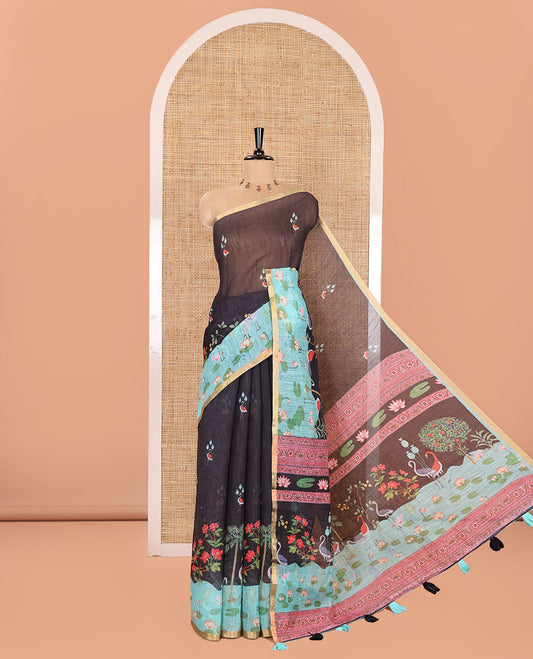 Black Linen Cotton Saree, Prettified with Crane and Floral Printed on Its Body, Subtle Piping Border, Captivating Contrast Pallu of Floral, Pichwai Lotus and Bird Designs, and Paired with a Contrast Blouse