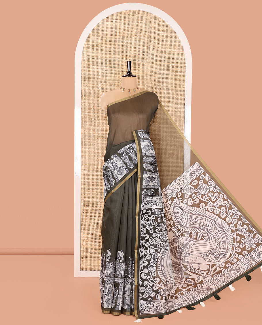Green Chanderi Cotton Saree, Highlighted with Kalamkari-Style Ancient Human Figurines Printed on Its Body, Subtle Zari Piping Border, Pallu Depicting Kalamkari Peacocks, and Paired with a Matching Blouse