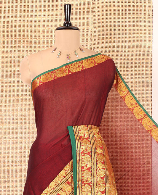 Maroon Plain Mercerised Cotton Saree, Complemented by a Contrast Traditional Border of Peacock, Elephant, and Peacock Eye Designs, Striped Pallu, and Paired with a Matching Blouse