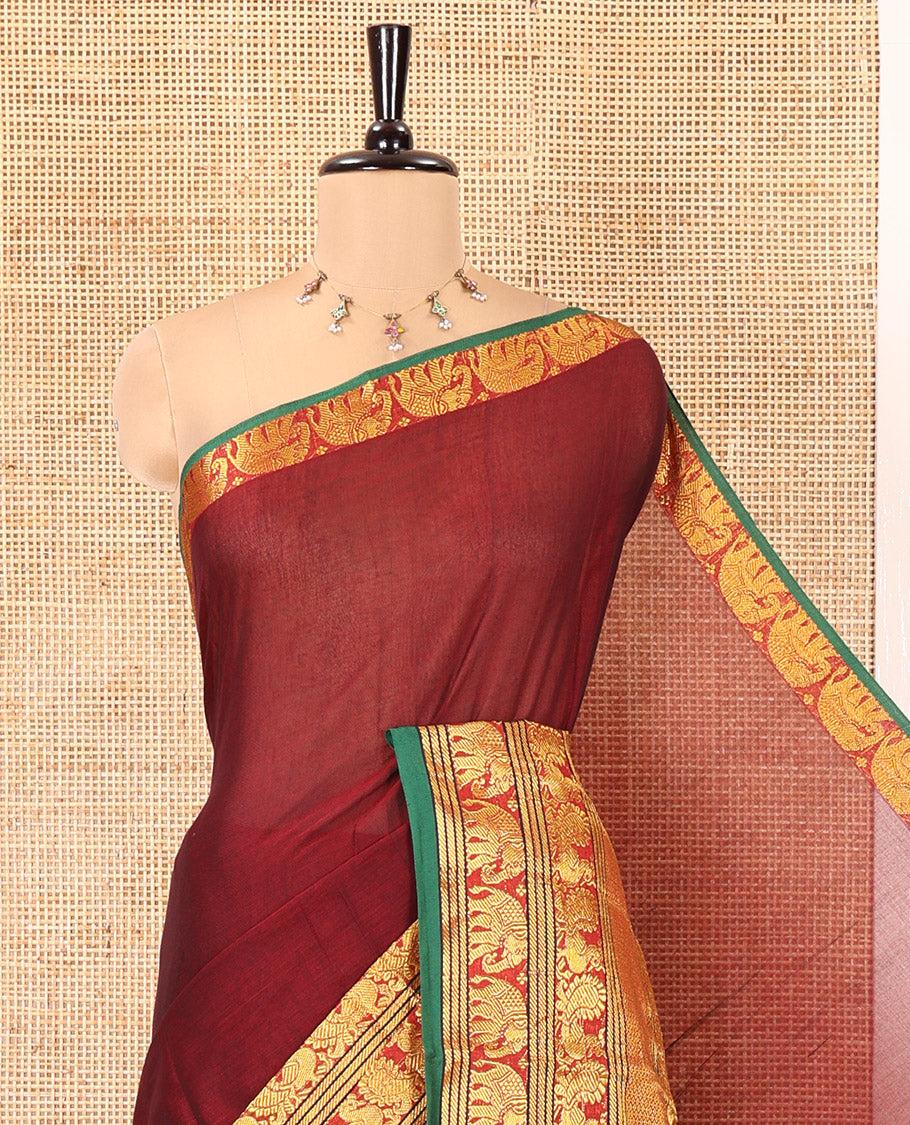 Maroon Plain Mercerised Cotton Saree, Complemented by a Contrast Traditional Border of Peacock, Elephant, and Peacock Eye Designs, Striped Pallu, and Paired with a Matching Blouse