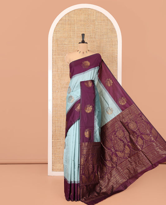 Dusky Pastel Green Art Silk Saree with Floral Zari Buttas All Over Its Body, Complemented by Contrast Floral Design Border, Intricately Designed Pallu, and Paired with a Contrast Blouse
