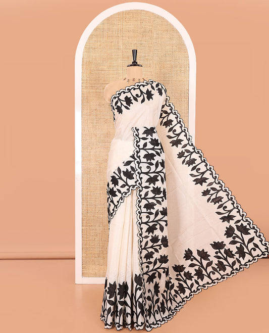 Cream and Black Plain Fancy Kota Silk Saree Sparsely Sparkled with Lotus Floral Applique Embroidered Scallop Border, Lotus Motifs Applique Embroidered Pallu, and a Contrast Plain Blouse