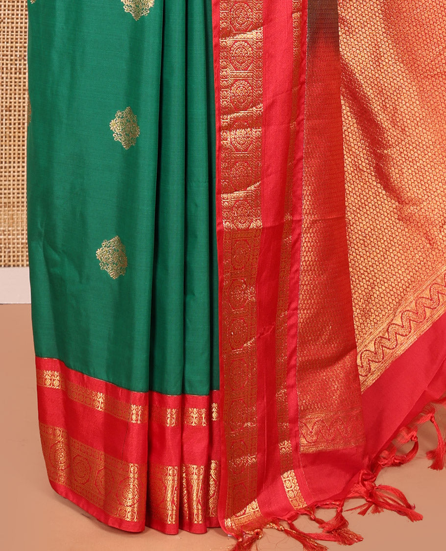 Green Kanchipuram Budget Silk Saree, Detailed with Zari Buttas All Over Its Body, Complemented by a Contrast Traditional Zari Rettai Pettu Border of Chakram Designs, Gracefully Embellished Pallu, and Paired with a Contrast Blouse