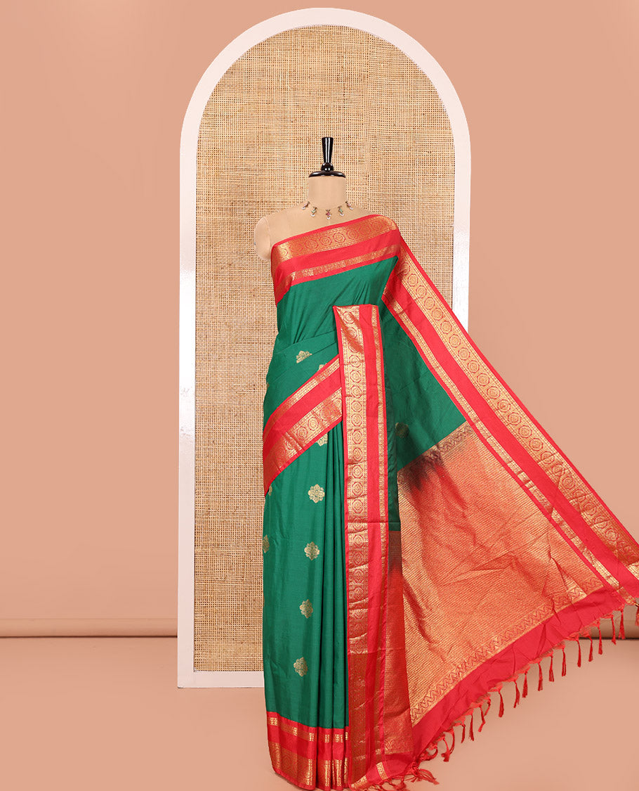 Green Kanchipuram Budget Silk Saree, Detailed with Zari Buttas All Over Its Body, Complemented by a Contrast Traditional Zari Rettai Pettu Border of Chakram Designs, Gracefully Embellished Pallu, and Paired with a Contrast Blouse