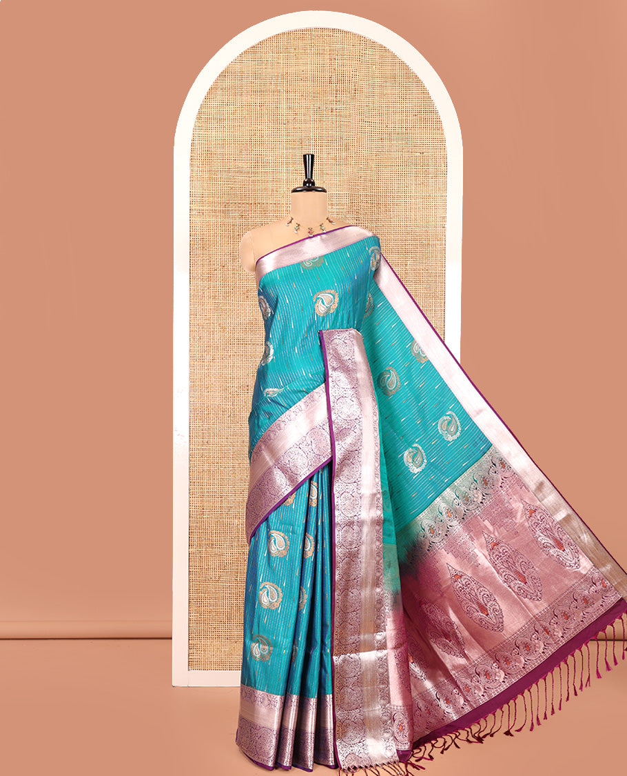 Ramar Blue Semi-Soft Silk Saree, Gracefully Embellished with Vaira Oosi, and Paisley Buttas All Over Its Body, Complemented by Contrast Traditional Border of Paisleys, Intricately Designed Pallu, and Paired with a Contrast Blouse