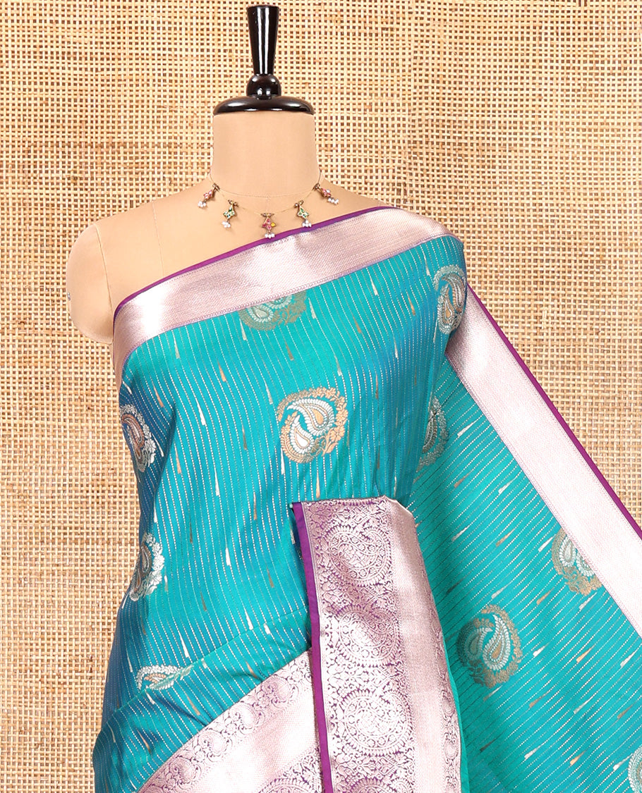 Ramar Blue Semi-Soft Silk Saree, Gracefully Embellished with Vaira Oosi, and Paisley Buttas All Over Its Body, Complemented by Contrast Traditional Border of Paisleys, Intricately Designed Pallu, and Paired with a Contrast Blouse