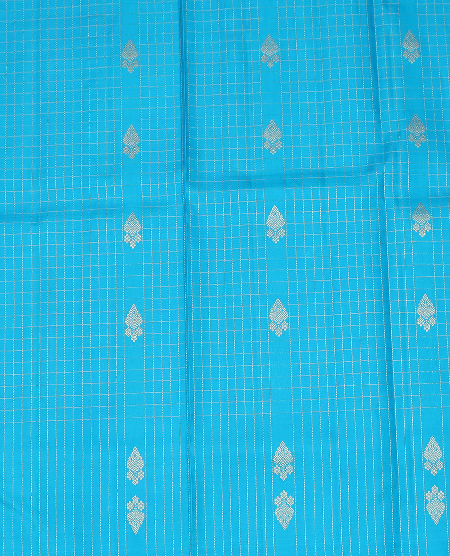 Blue Pure Silk Half-Saree Adorned with Zari Buttas Enclosed in Checks on the Skirt, Complemented by a Contrast Border Featuring Thilakam Mokku, Arumbu Manga, and Mayil Kann Designs, Paired with a Contrast Blouse, and a Jaal Design Dhavani