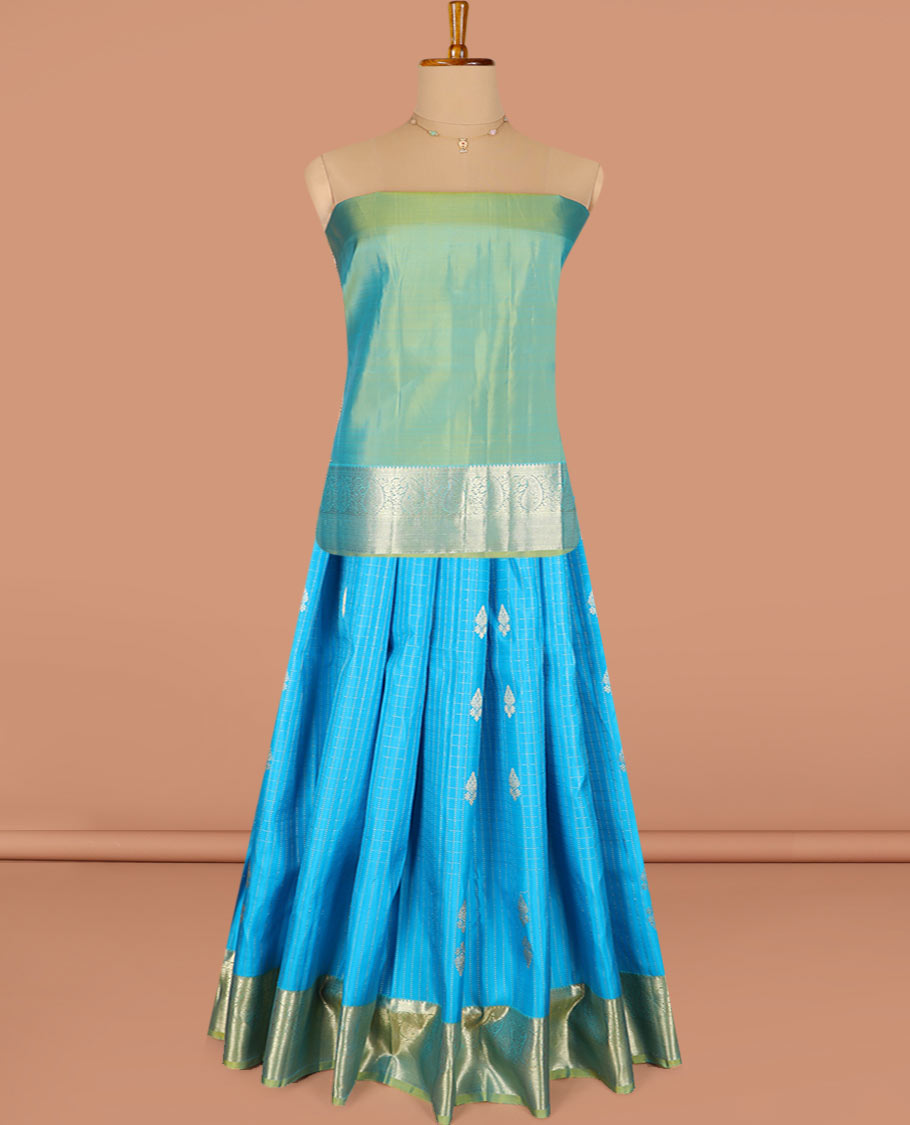 Blue Pure Silk Half-Saree Adorned with Zari Buttas Enclosed in Checks on the Skirt, Complemented by a Contrast Border Featuring Thilakam Mokku, Arumbu Manga, and Mayil Kann Designs, Paired with a Contrast Blouse, and a Jaal Design Dhavani
