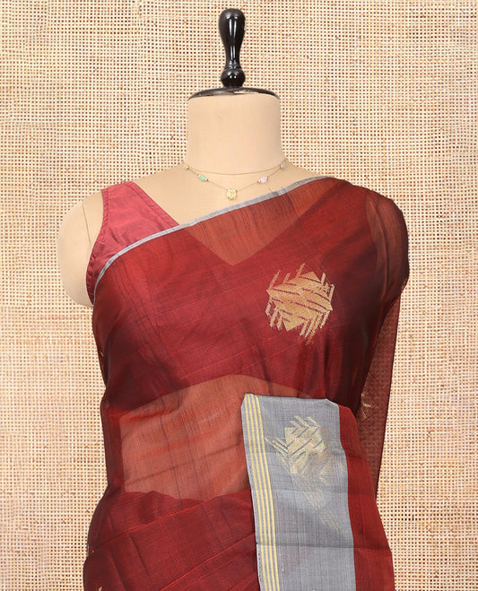 Maroon Cotton Saree, Complemented by a Contemporary Leaf Buttas, a Contrast One-Side Zari Motif Border, a Chevron Pallu, and a Contrast Blouse
