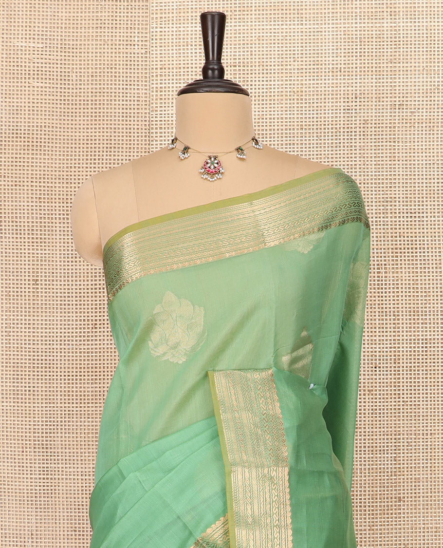 Green Silk Cotton Saree Gracefully Embellished with Zari Buttas, Complemented by a Contrast Border Steeped with Traditional Designs, Featuring Pallu of Circle Motifs, and Paired with Contrast Blouse