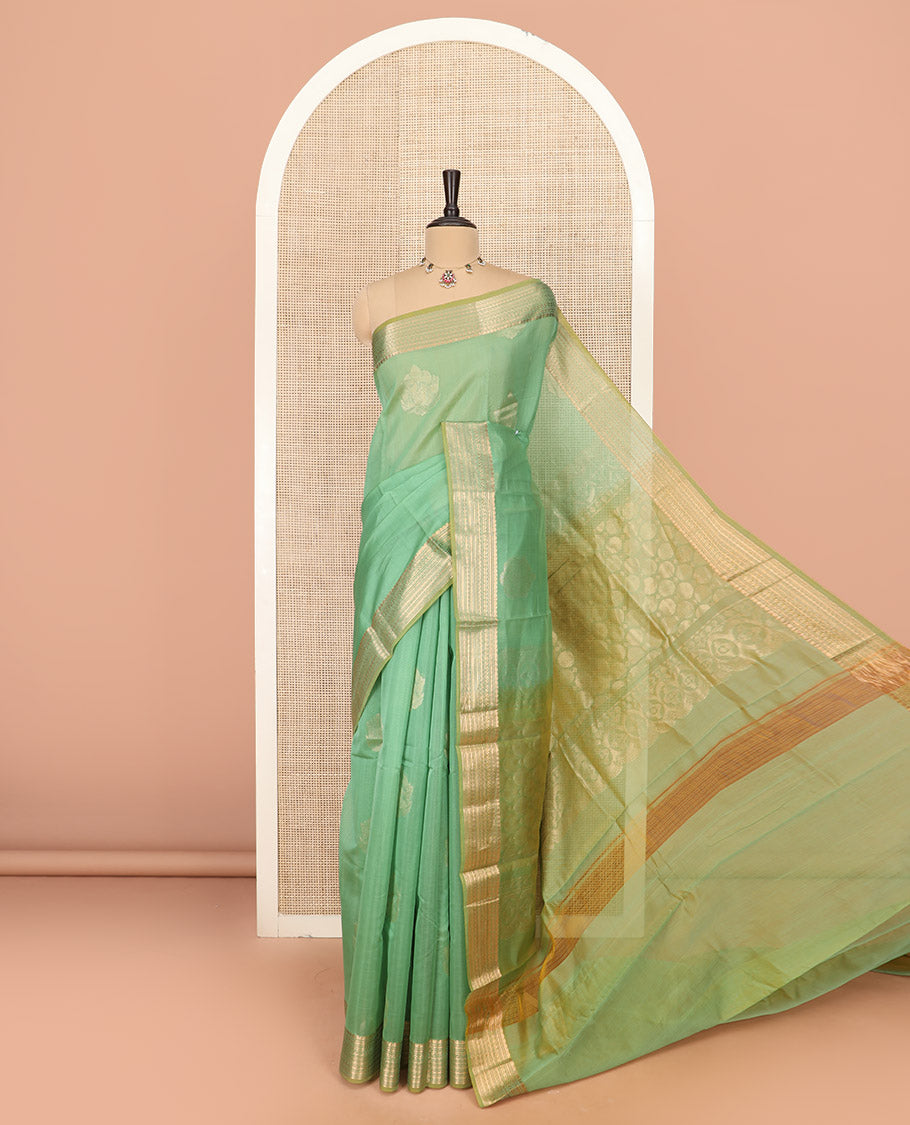 Green Silk Cotton Saree Gracefully Embellished with Zari Buttas, Complemented by a Contrast Border Steeped with Traditional Designs, Featuring Pallu of Circle Motifs, and Paired with Contrast Blouse