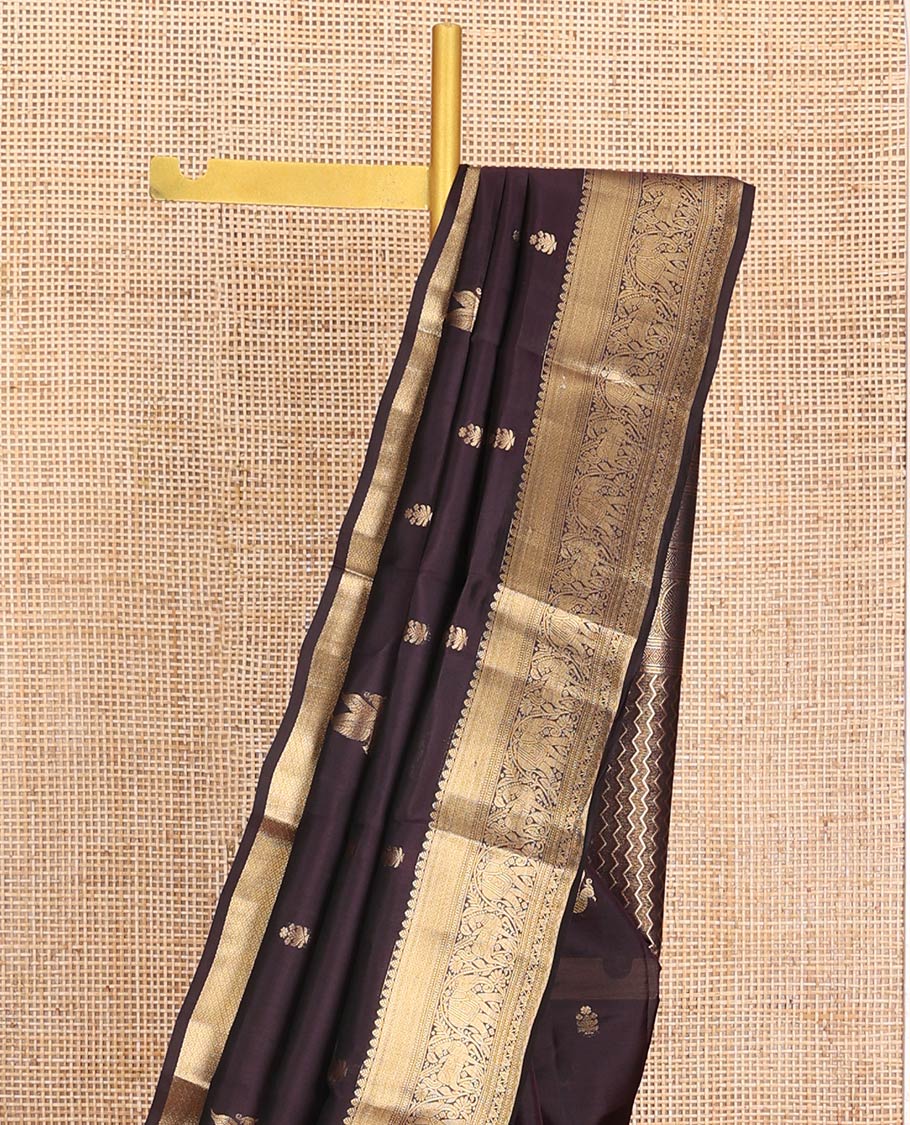 Brown Vasundhara Lite-Silk Mix Saree, Delicately Woven with Zari Buttas on Its Body, Highlighted by a Zari Border of Mayil Kann, Muthu, Yaanai, Kuthirai, and Lavangam Designs, Gracefully Embellished Pallu, and Paired with a Matching Blouse