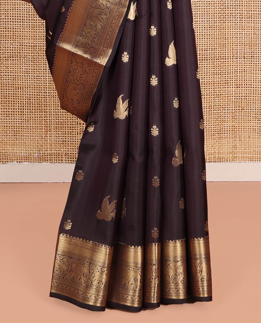 Brown Vasundhara Lite-Silk Mix Saree, Delicately Woven with Zari Buttas on Its Body, Highlighted by a Zari Border of Mayil Kann, Muthu, Yaanai, Kuthirai, and Lavangam Designs, Gracefully Embellished Pallu, and Paired with a Matching Blouse