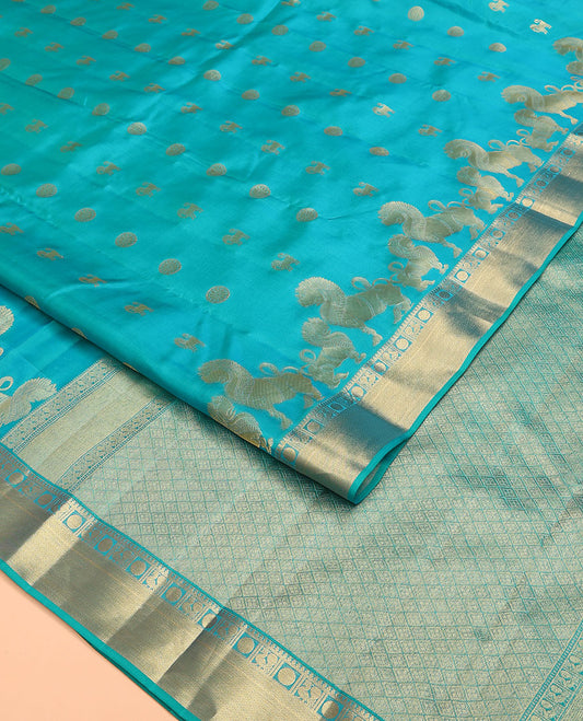 Blue Vasundhara Lite Silk Mix Saree, Gracefully Embellished with Yaali, Singam, and Chakram Buttas on Its Body, Highlighted by a Zari Border of Thilakam Mokku, Poun, Mayil, and Mayil Kann Designs, Subtle Jaal Pallu, and Paired with a Matching Blouse