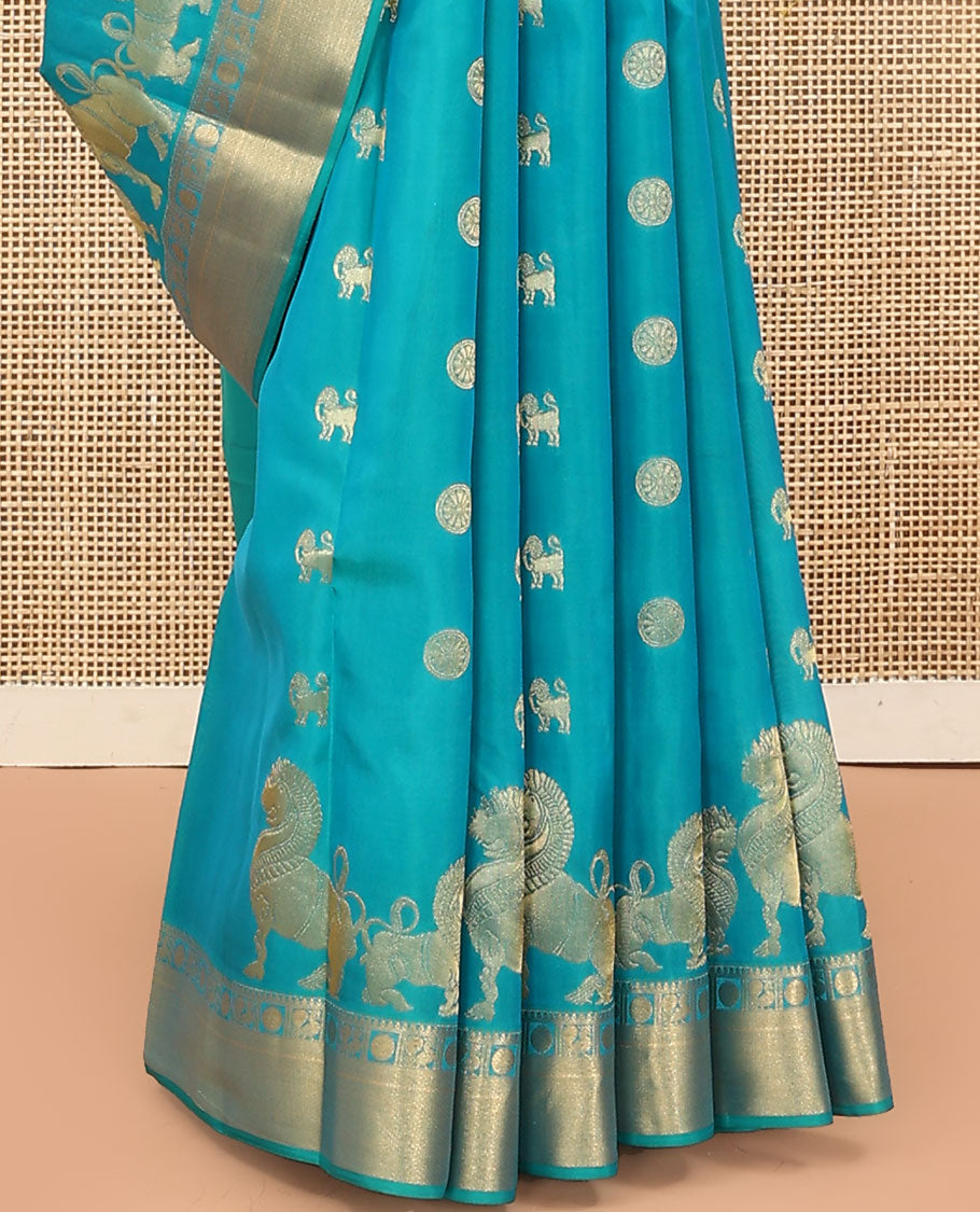 Blue Vasundhara Lite Silk Mix Saree, Gracefully Embellished with Yaali, Singam, and Chakram Buttas on Its Body, Highlighted by a Zari Border of Thilakam Mokku, Poun, Mayil, and Mayil Kann Designs, Subtle Jaal Pallu, and Paired with a Matching Blouse