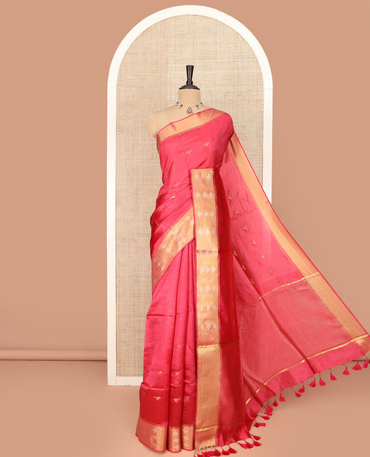 Red Banana Pith Saree Elegantly Framed with Zari Buttas, Artfully Detailed Border with Zari Designs, Gleaming Zari Stripes Woven Pallu, and Paired with a Matching Plain Blouse