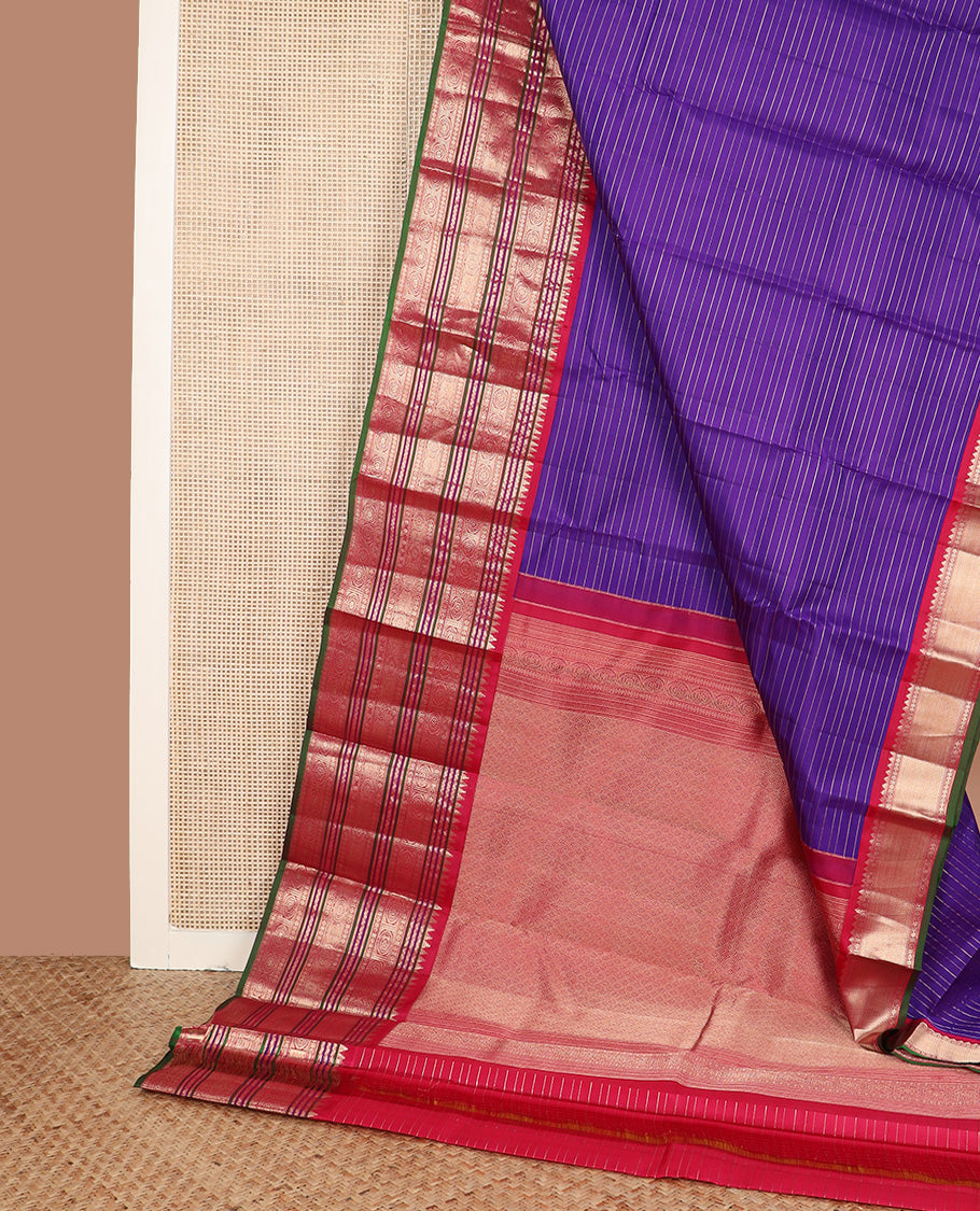 Blue zari stripes silk saree, contrast korvai border of rekku, neli, kamalam, and poo chakram designs, and jaal pallu