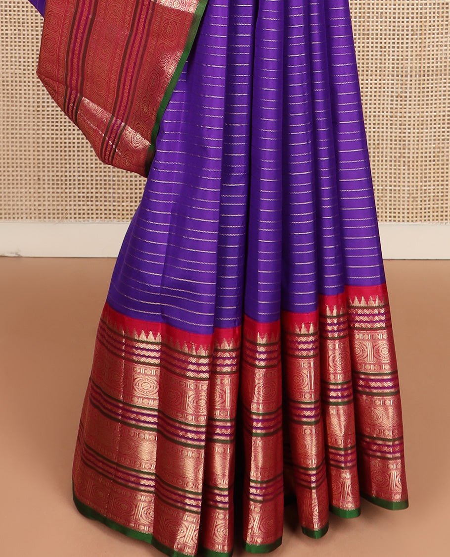 Blue zari stripes silk saree, contrast korvai border of rekku, neli, kamalam, and poo chakram designs, and jaal pallu