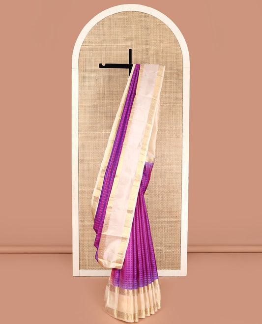 Purple Vasundhara Silk Saree, Steeped in Richness of Micro-Zari Checks All Over Its Body, Complemented by Contrast Rettai Pettu Border of Thilakam Mokku, Diamond, and Cross Kamalam Designs, Grand Jaal Pallu, and Paired with a Contrast Blouse
