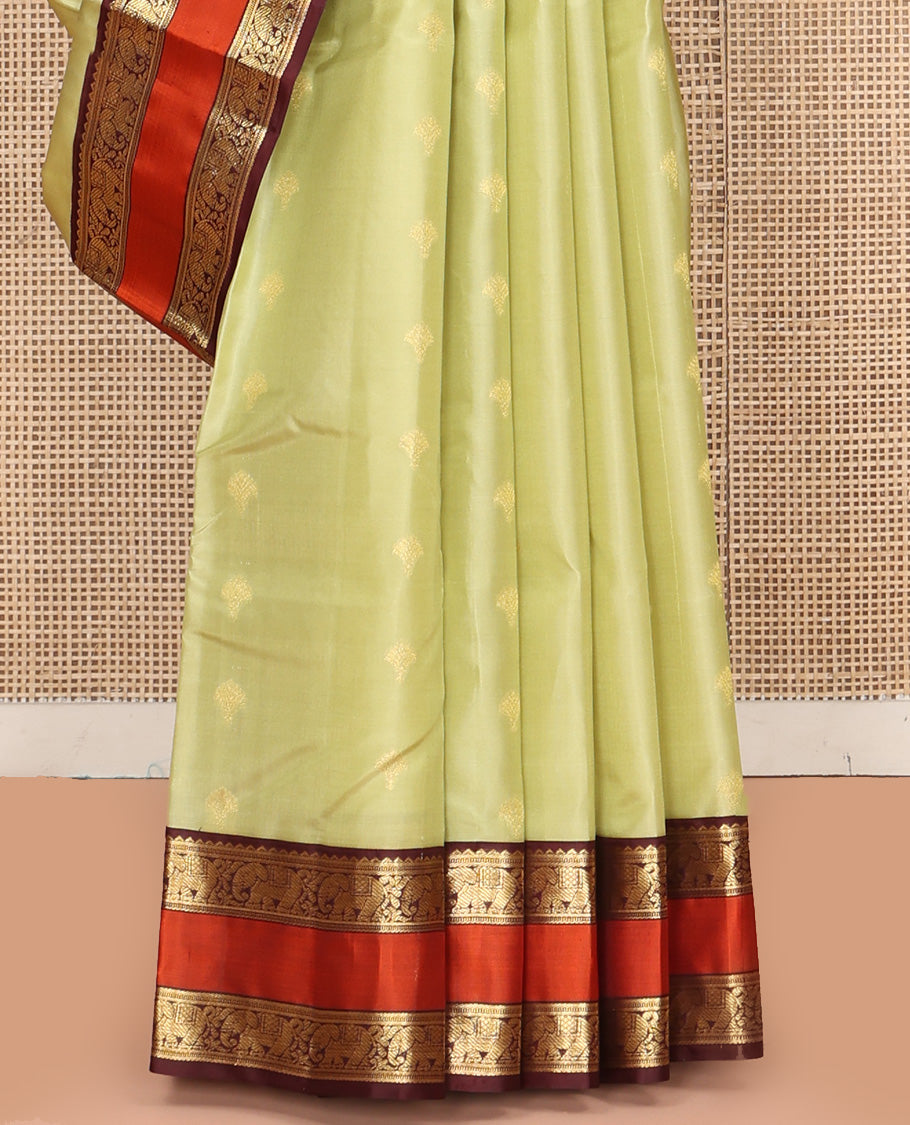 Green Vasundhara Silk Saree, Woven with Zari Buttas All Over Its Body Complemented by Contrast Rettai Pettu Border of Rekku and Yaanai Designs, Grand Pallu and Paired with a Contrast Blouse
