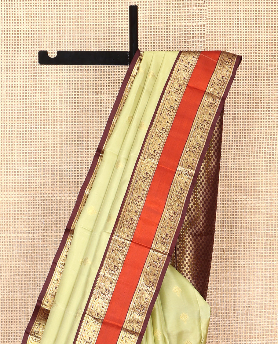 Green Vasundhara Silk Saree, Woven with Zari Buttas All Over Its Body Complemented by Contrast Rettai Pettu Border of Rekku and Yaanai Designs, Grand Pallu and Paired with a Contrast Blouse