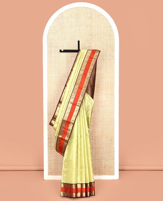 Green Vasundhara Silk Saree, Woven with Zari Buttas All Over Its Body Complemented by Contrast Rettai Pettu Border of Rekku and Yaanai Designs, Grand Pallu and Paired with a Contrast Blouse