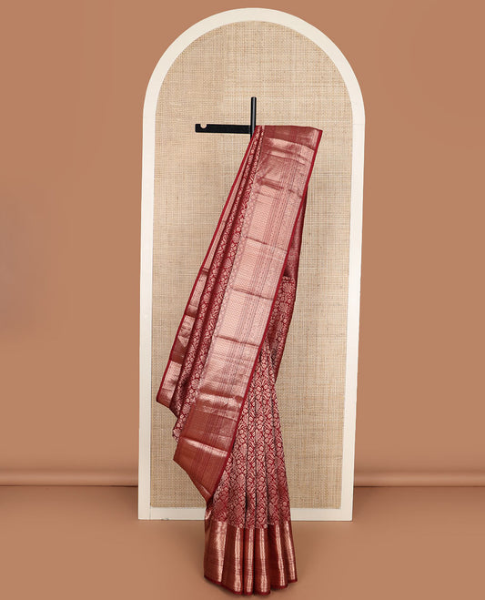 Maroon jacquard Kanchipuram wedding silk saree, zari border of rekku, muthu, chakram, vanki, rekku, floral and paisley designs, and pallu of intricate paisleys
