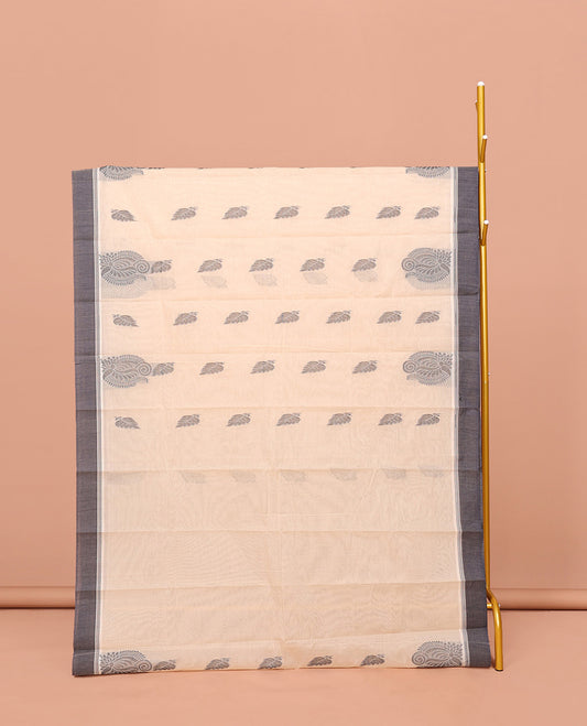 Cream Kanchi Cotton Saree, Embellished with Leaf Buttas All Over Its Body, Complemented by Contrast Border, Pallu of Intricate Designs, and Paired with a Matching Blouse