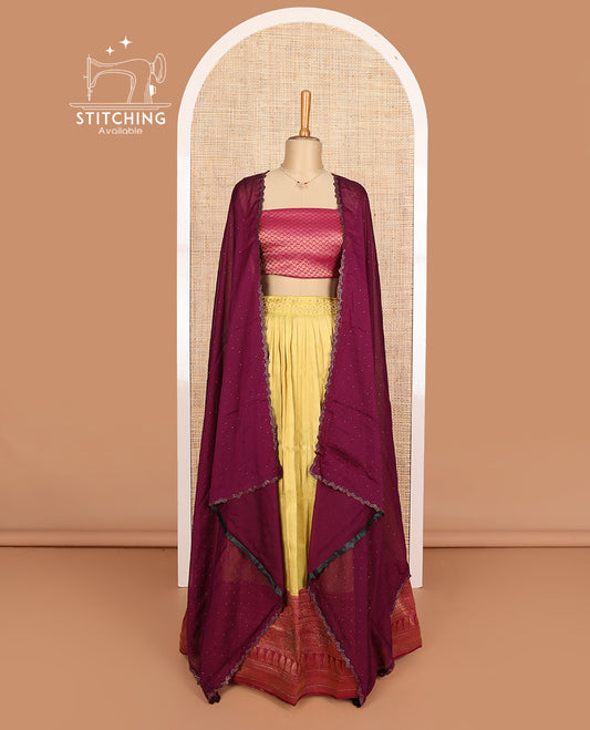 Yellow art silk half-saree, brocade with contrast traditional border skirt, contrast maroon brocade blouse, scallop stone work dhavani, and detachable belt