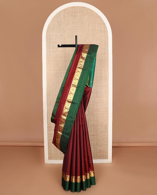 Maroon zari buttas Kanchipuram silk saree, contrast border of thilakam mokku, and mayil designs, and zari design pallu