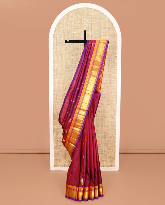 Maroon Kanchipuram Silk Saree, Mesmerized with Zari Buttas All Over Its Body, Complemented by a Contrast One-Sided Border of Panner Sombu, Banaras, Muthu, and Mayil Kann Designs, Pallu of Floral Designs, and Comes Without a Blouse