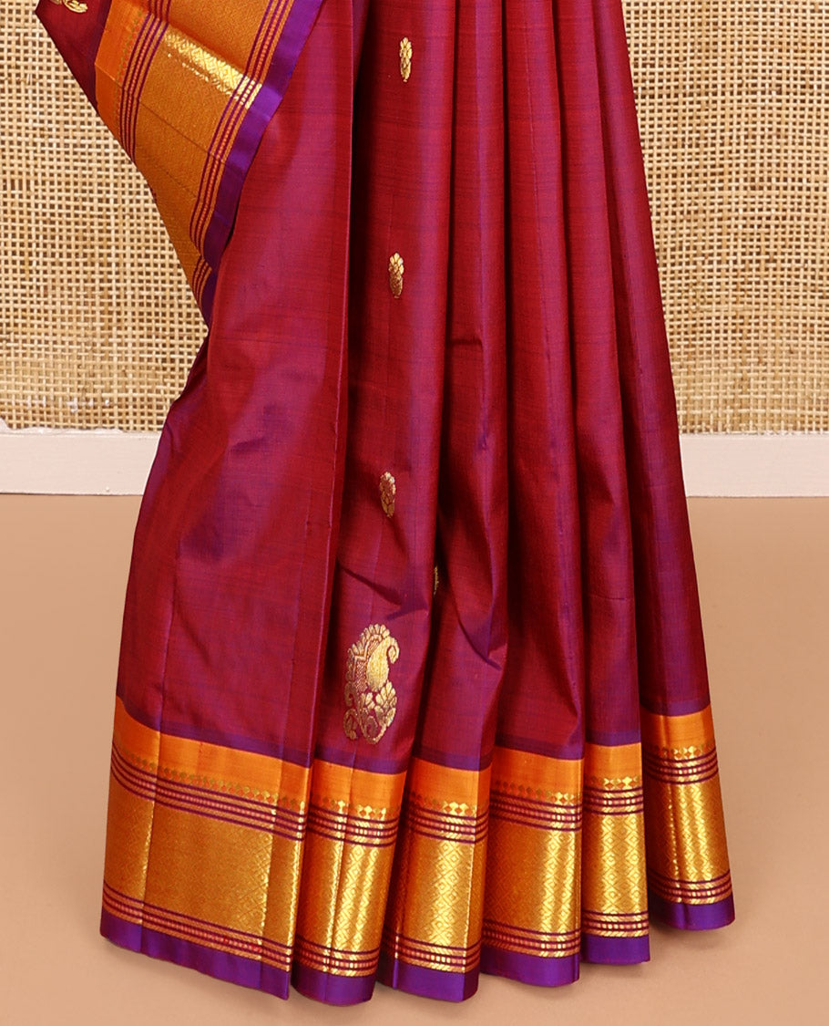 Maroon Kanchipuram Silk Saree, Mesmerized with Zari Buttas All Over Its Body, Complemented by a Contrast One-Sided Border of Panner Sombu, Banaras, Muthu, and Mayil Kann Designs, Pallu of Floral Designs, and Comes Without a Blouse