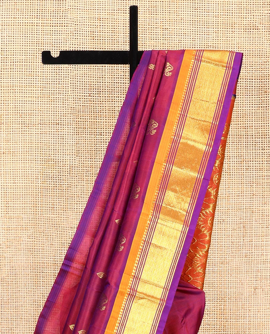 Maroon Kanchipuram Silk Saree, Mesmerized with Zari Buttas All Over Its Body, Complemented by a Contrast One-Sided Border of Panner Sombu, Banaras, Muthu, and Mayil Kann Designs, Pallu of Floral Designs, and Comes Without a Blouse