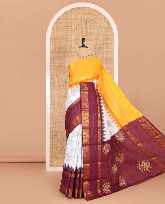 White kolam motifs printed Sungudi cotton saree, contrast yellow-maroon ganga jamuna rettai pettu traditional zari border, floral motifs pallu, and a contrast elephant motifs blouse
