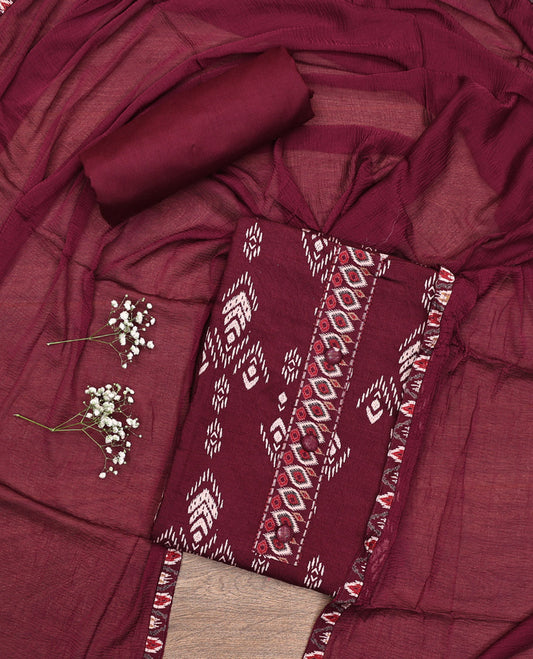 Maroon Material Chudidar Set, Bedecked with Ikkat-Style Motifs Print on Rayon Top, a Plain Cotton Bottom, and Paired with a Plain Chiffon Dupatta
