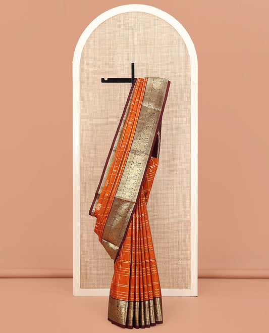 Orange Venkatagiri Silk Saree, Detailed with Zari Buttas Enclosed Checks All Over Its Body, Complemented by a Contrast Traditional Zari Border of Yaal Designs, Pallu of Ogee Designs, and Paired with a Contrast Blouse