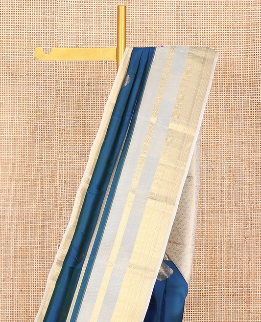 Blue Vasundhara Silk Saree,Elegantly Detailed with Zari Buttas, Complemented by a Contrast Varisai Pettu Border of Kodi Visiry, Mayil, Muthu, Neli, and Kuyil Kann Designs, Majestically Detailed Pallu of Intricate Designs, and Paired with a Contrast Blouse