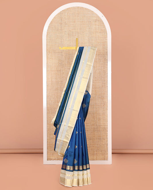 Blue Vasundhara Silk Saree,Elegantly Detailed with Zari Buttas, Complemented by a Contrast Varisai Pettu Border of Kodi Visiry, Mayil, Muthu, Neli, and Kuyil Kann Designs, Majestically Detailed Pallu of Intricate Designs, and Paired with a Contrast Blouse
