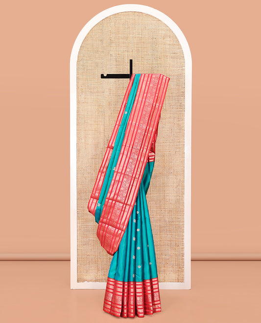 Rama Vasundhara Silk Saree, Accentuated with Zari Buttas All Over Its Body, Complemented by a Contrast Varisai Pettu Border of Thilakam, Neli, Laddu Kamalam, and Kodi Visiry Designs, Grand Pallu of Butta Enclosed Checks, and Paired with a Contrast Blouse