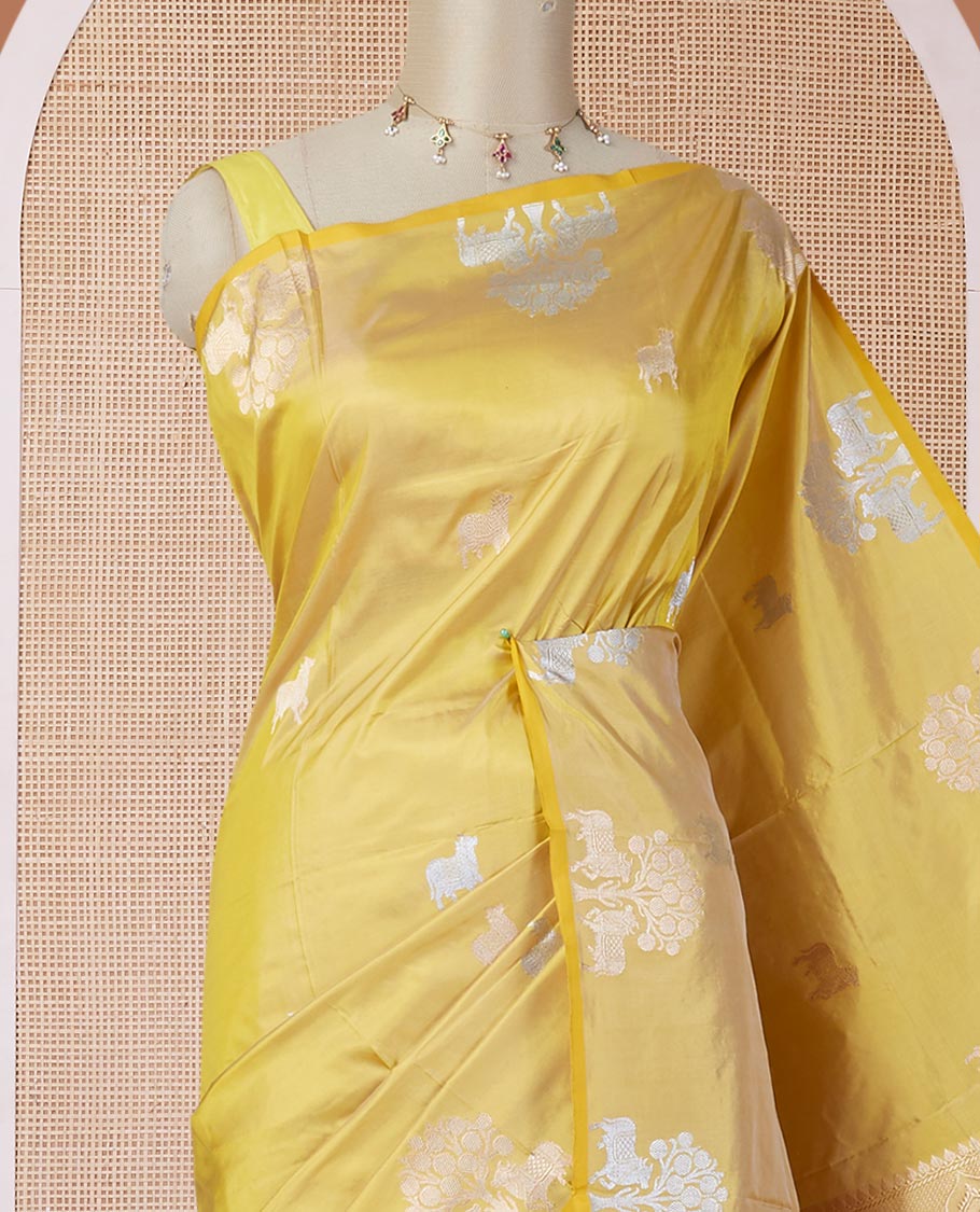 Borderless yellow katan silk saree with pichwai under a tree motifs in zari, pallu of mughal-style & dobble-style motifs